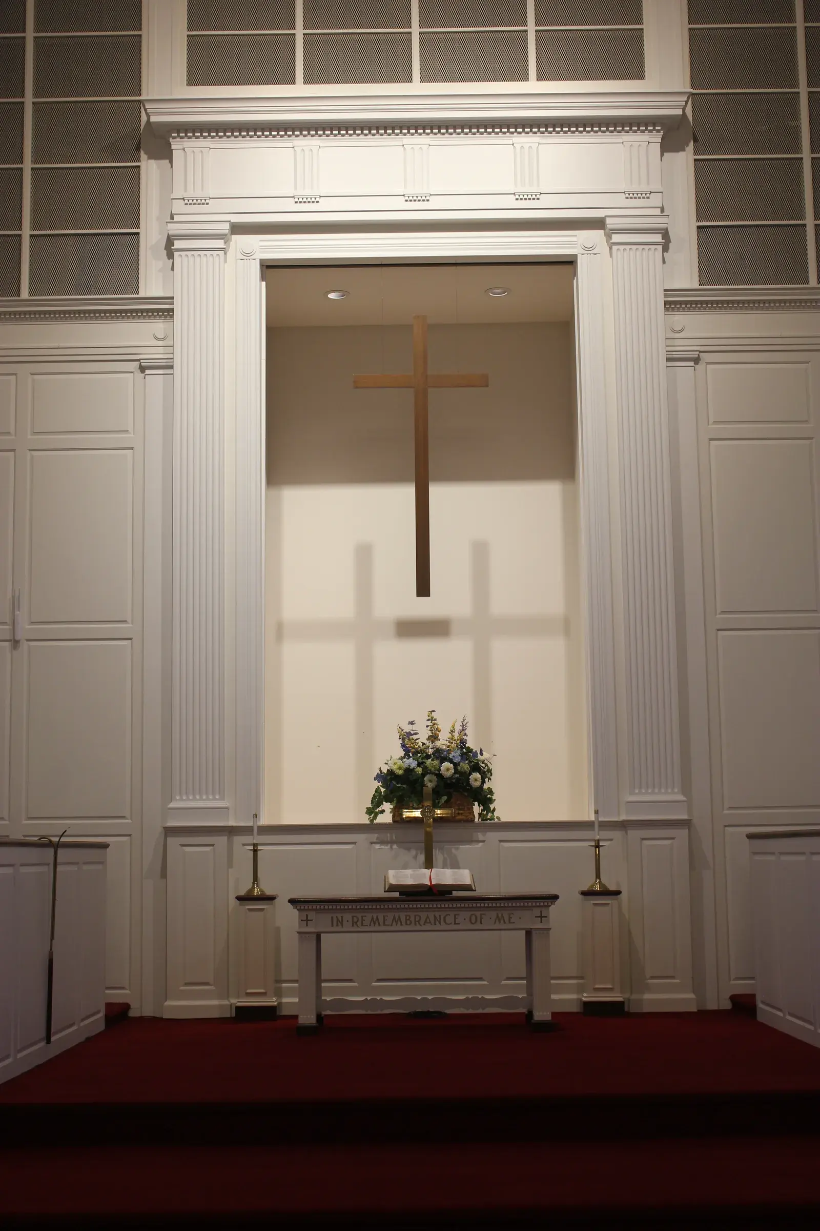 The wooden cross above the communion table in the sanctuary of Second Baptist Church of Suffield